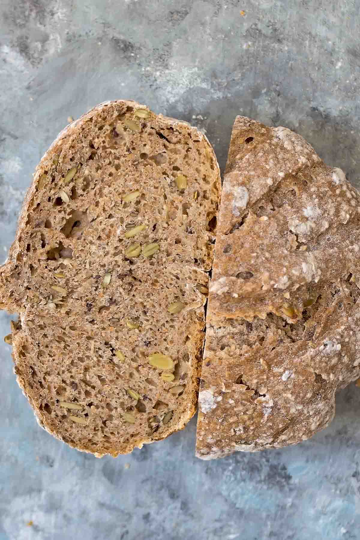 Halved homemade multigrain sourdough bread loaf