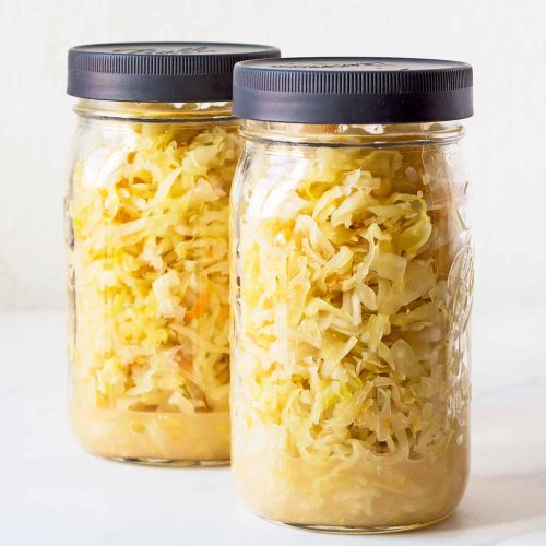 2 mason jars with finished sauerkraut