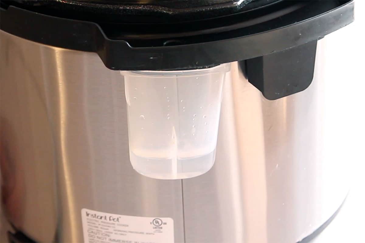 Closeup of condensation collector in back of pressure cooker