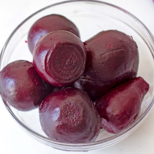 peeled pressure cooked beets in small glass bowl