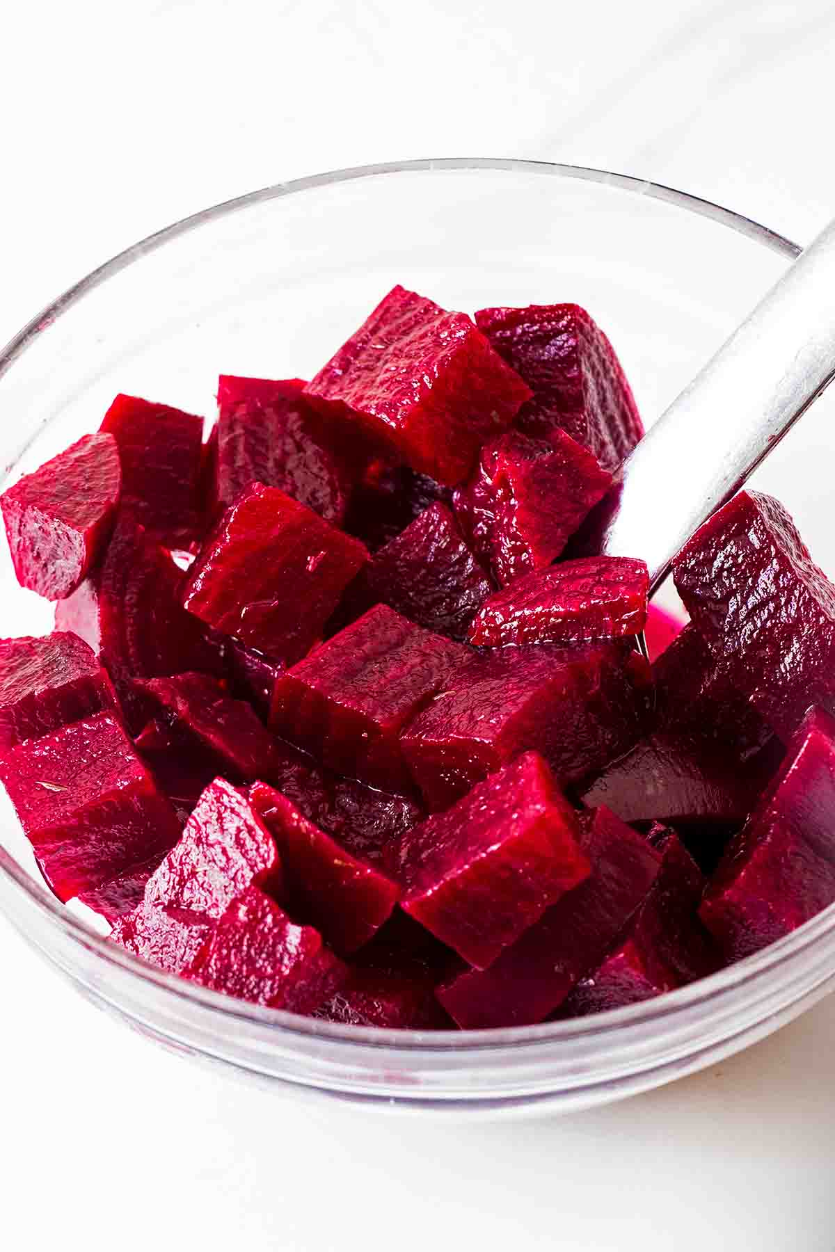 small glass bowl with quick pickled beetroot cubes and spoon