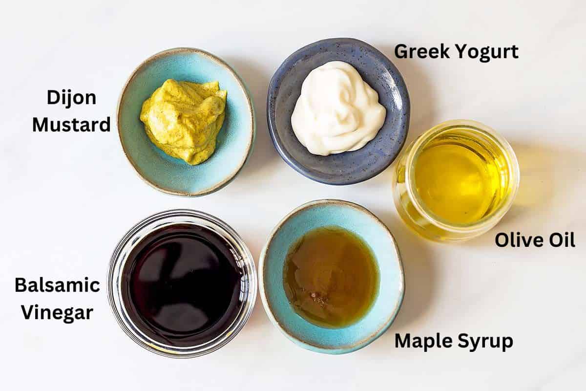 flat lay of 5 small bowls with individual ingredients for creamy balsamic dressing