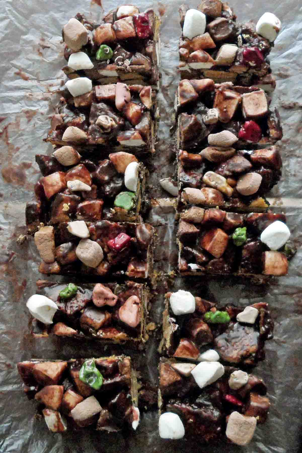 bird's eye view of a pan of rocky road marshmallow bars cut up into squares on parchment paper