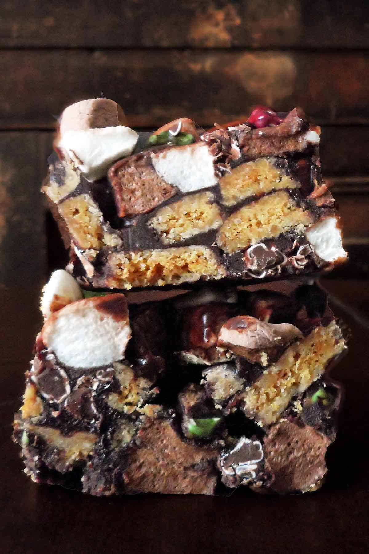 two rocky road squares stacked on top of each other on dark wooden table