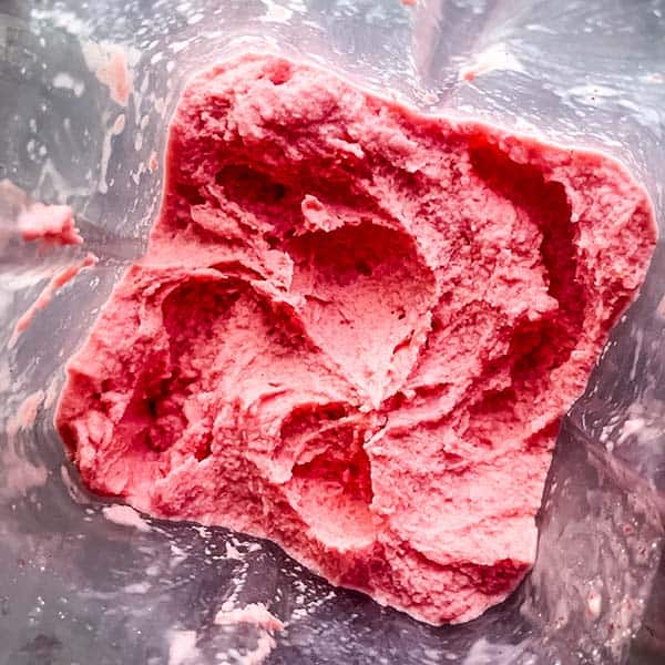 smoothly blended strawberry frozen yogurt in blender jar