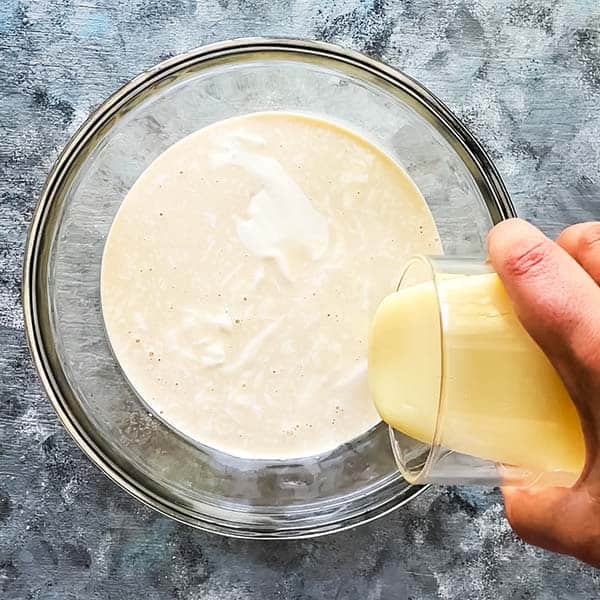 mixing three types of milks in large glass bowl