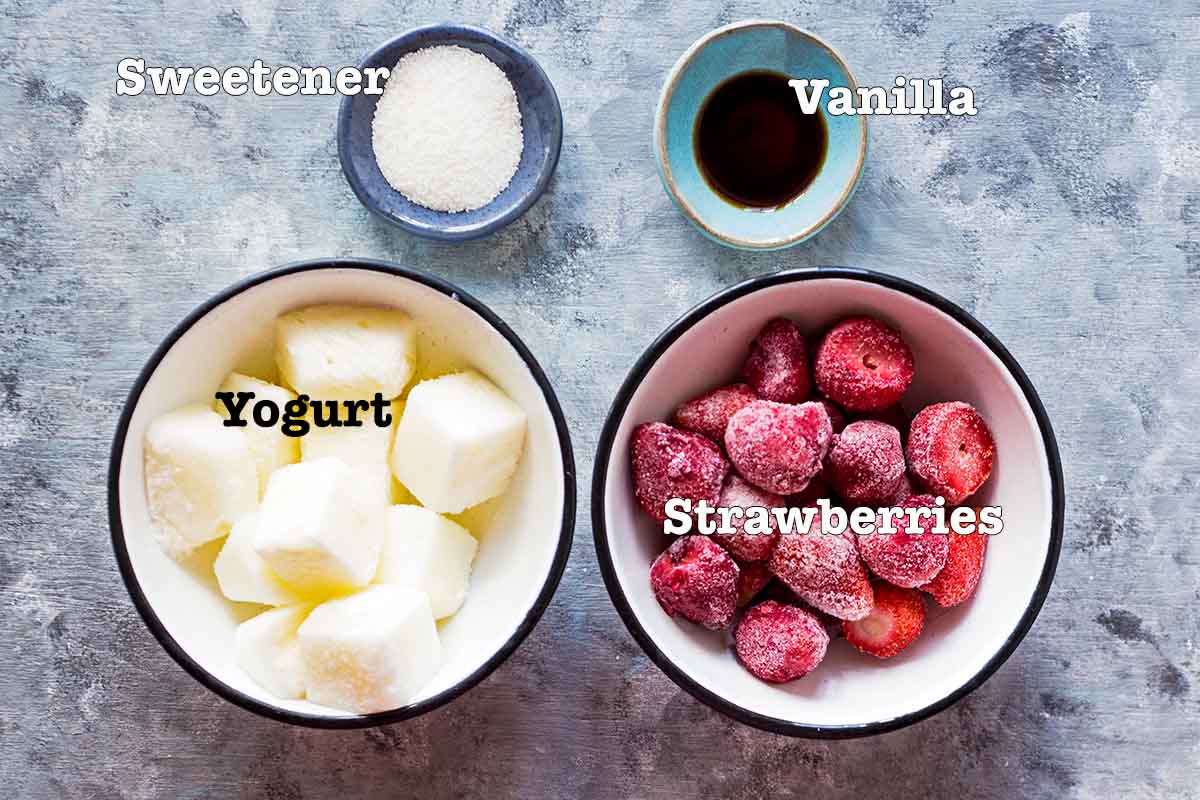 ingredients for strawberry frozen yogurt laid out in individual bowls