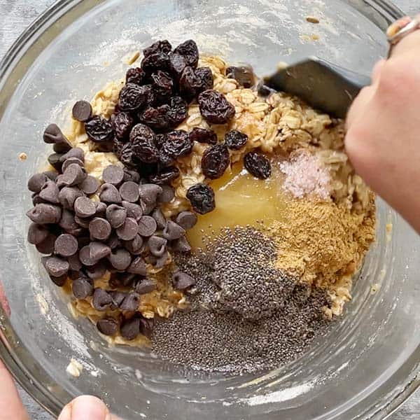 spatula mixing protein cookie dough in glass bowl
