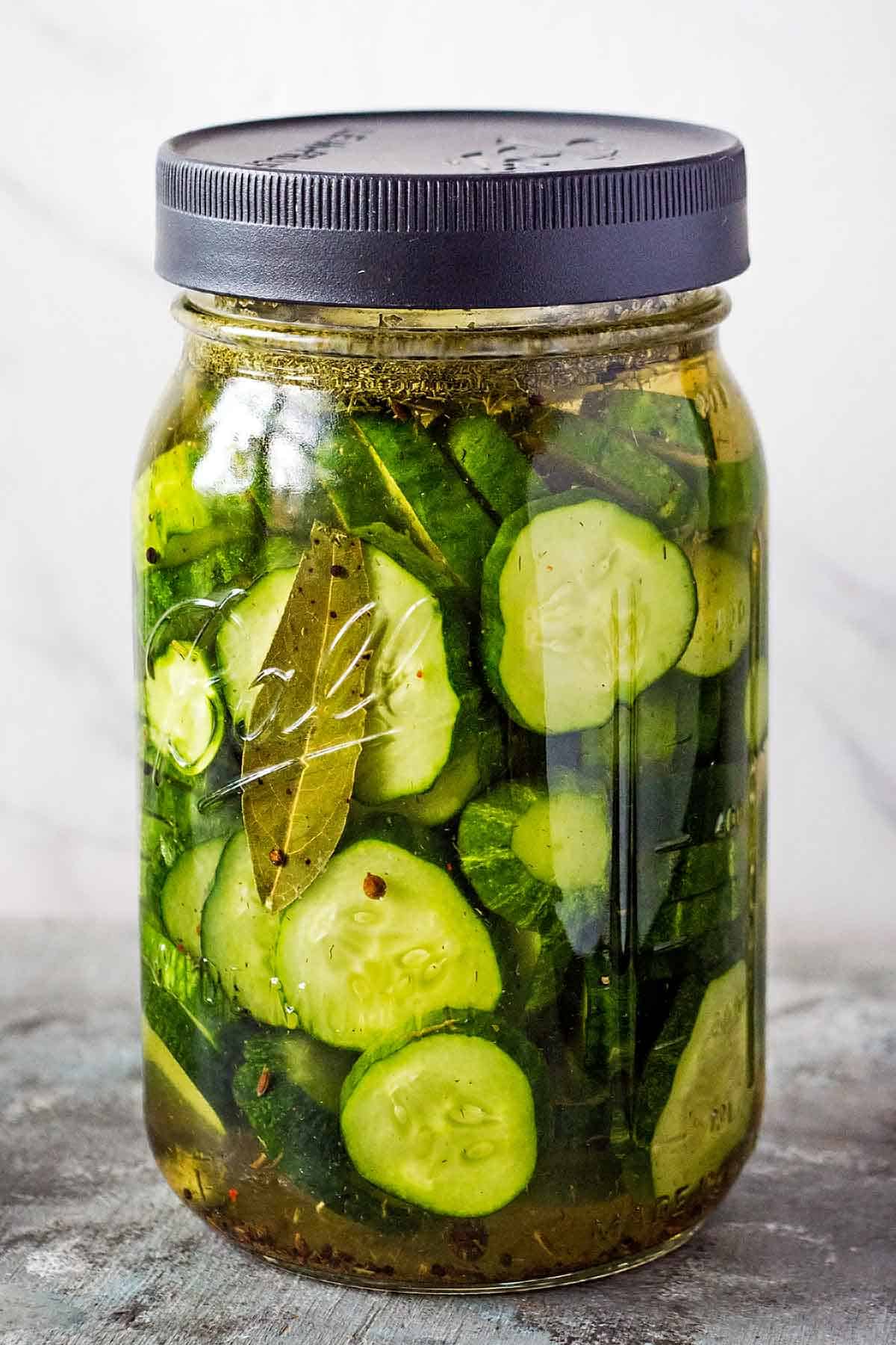 sliced cucumbers in jar before fermenting
