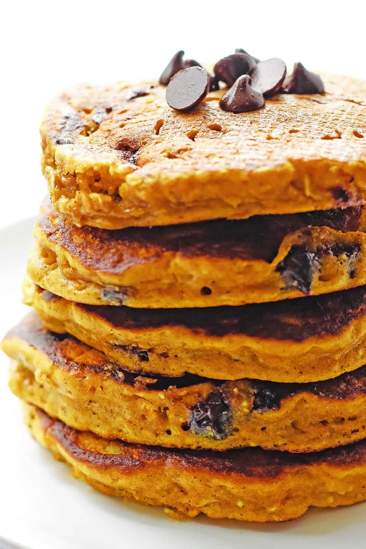 close up of stack of pumpkin pancakes with oatmeal and chocolate chips