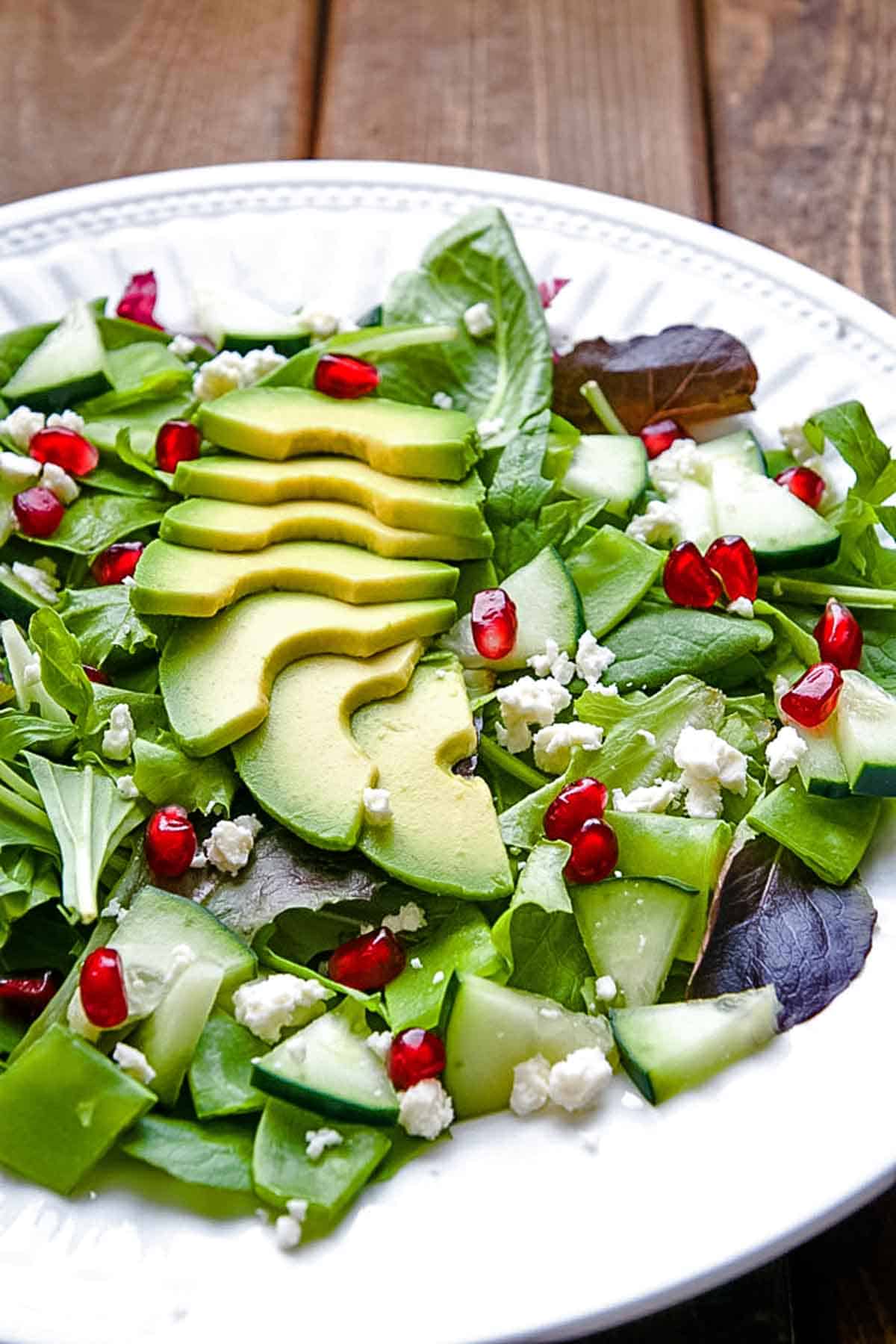 Green Goddess Salad with avocado pomegranate and goat cheese crumbles