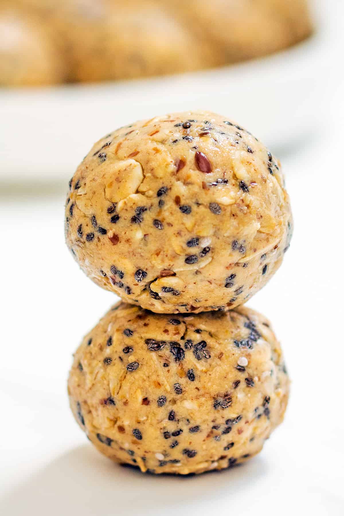 two oatmeal protein peanut butter balls stacked on top of each other