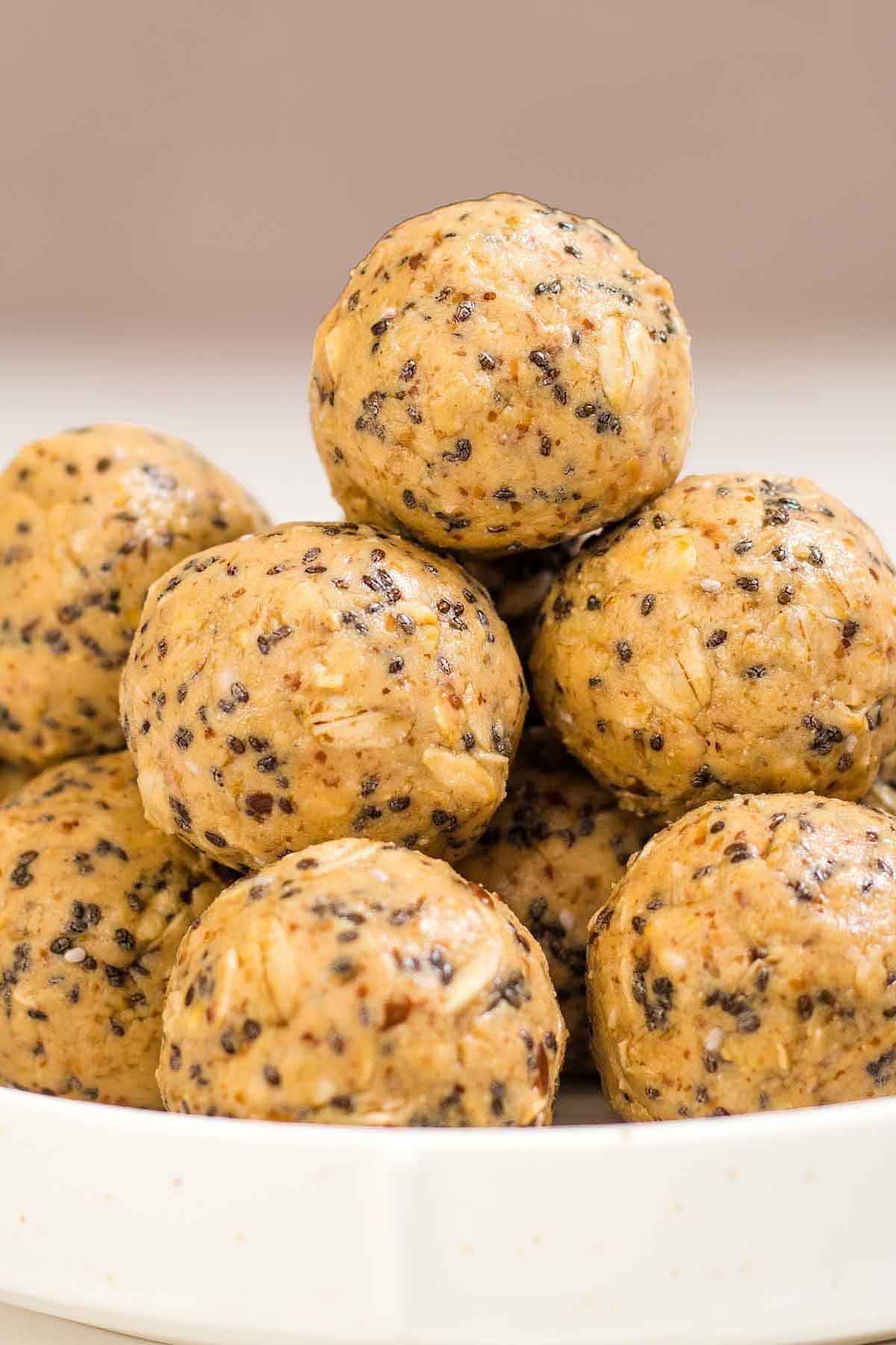peanut butter oatmeal protein balls stacked on a white saucer