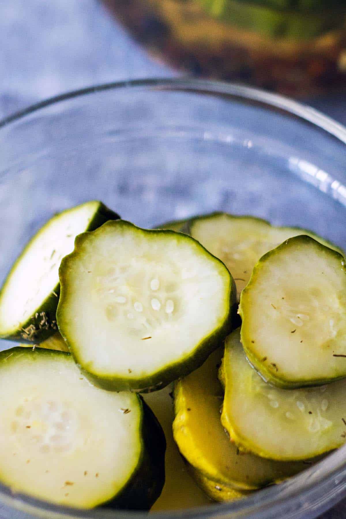 small glass bowl with easy fridge pickle slices
