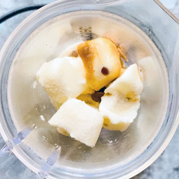 frozen yogurt cubes and other ingredients in blender jug