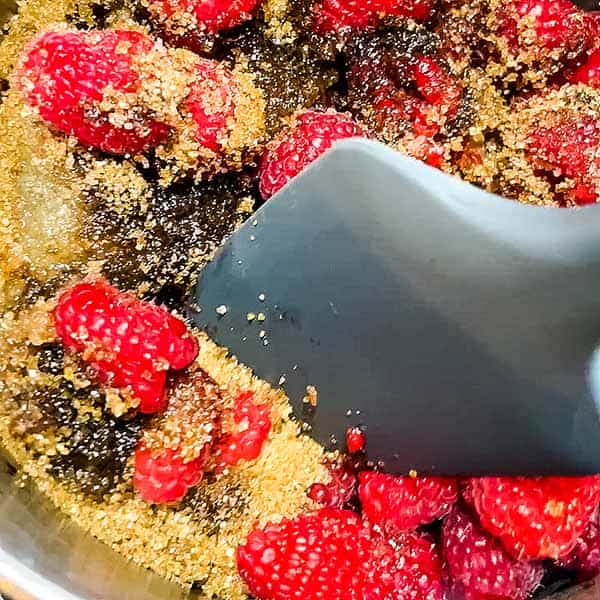 stirring raspberry jam