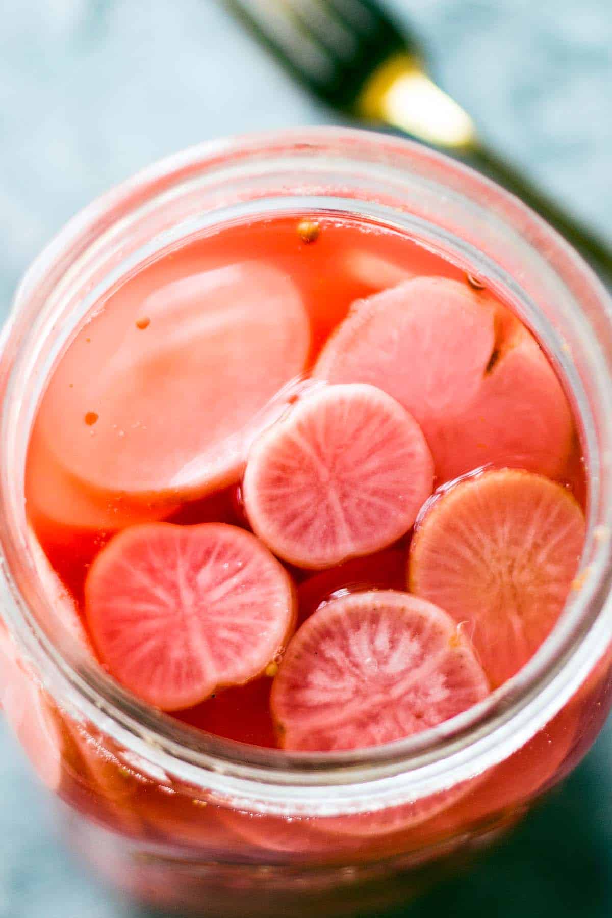 close up of fermented radish slices in jar