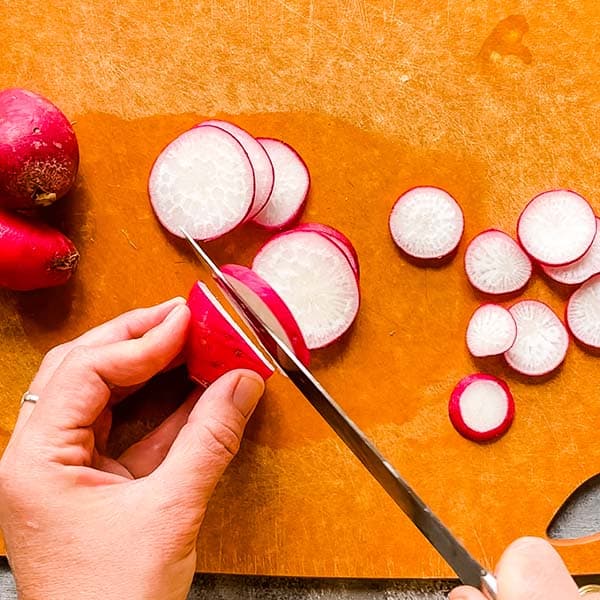 slicing radishes on cutting board