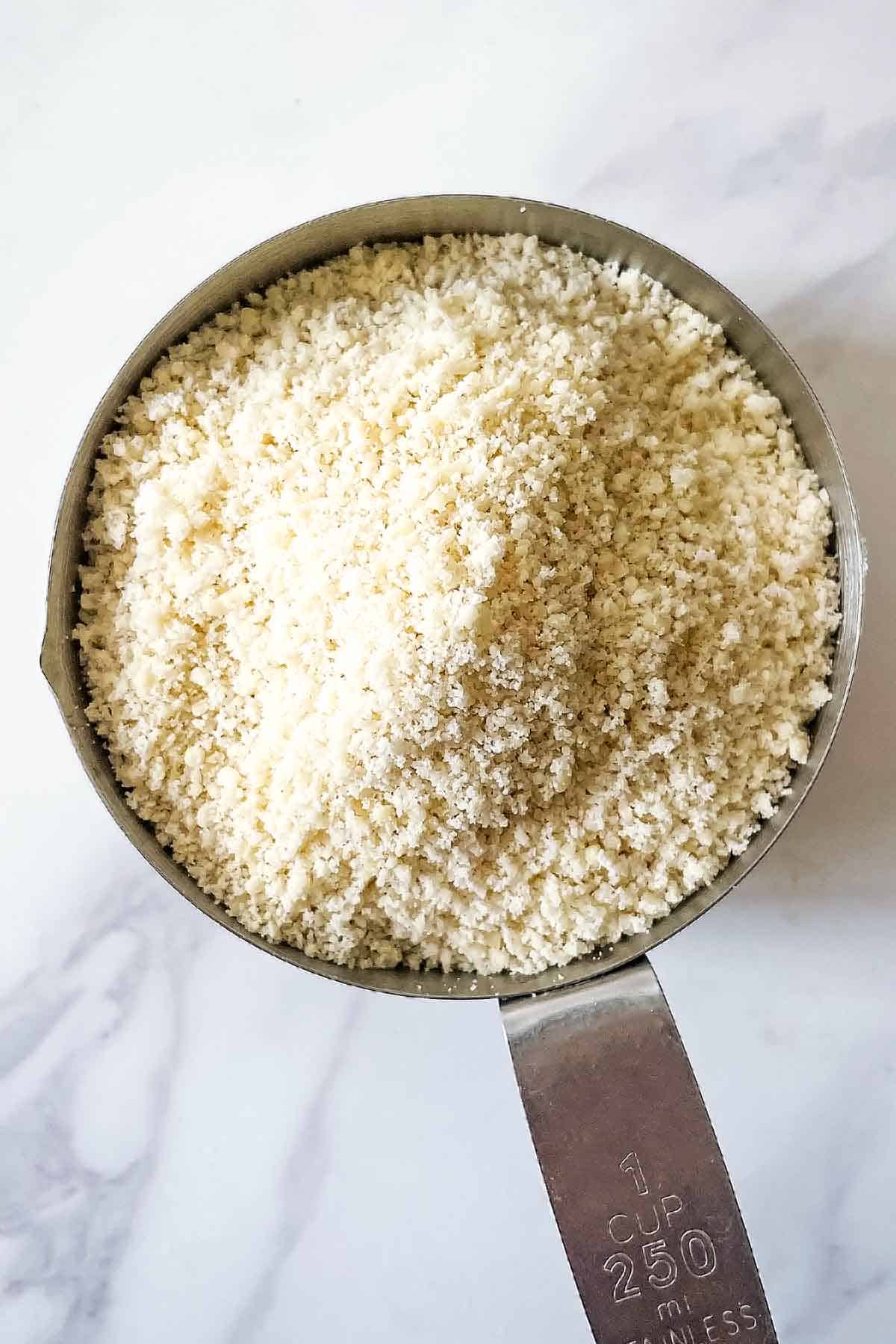 homemade almond flour in measuring cup