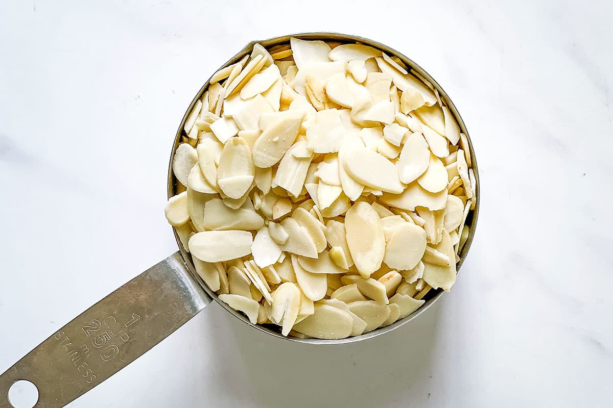 sliced almonds in measuring cup