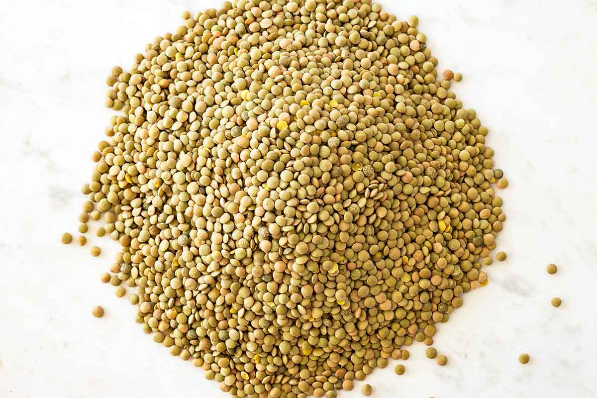 dry green lentils on marble counter