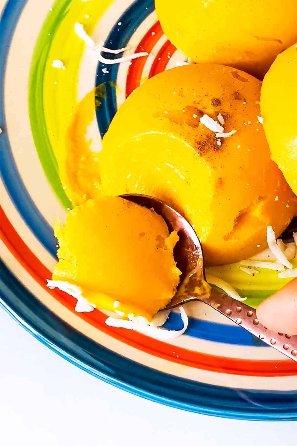 dessert spoon scooping mango sorbet