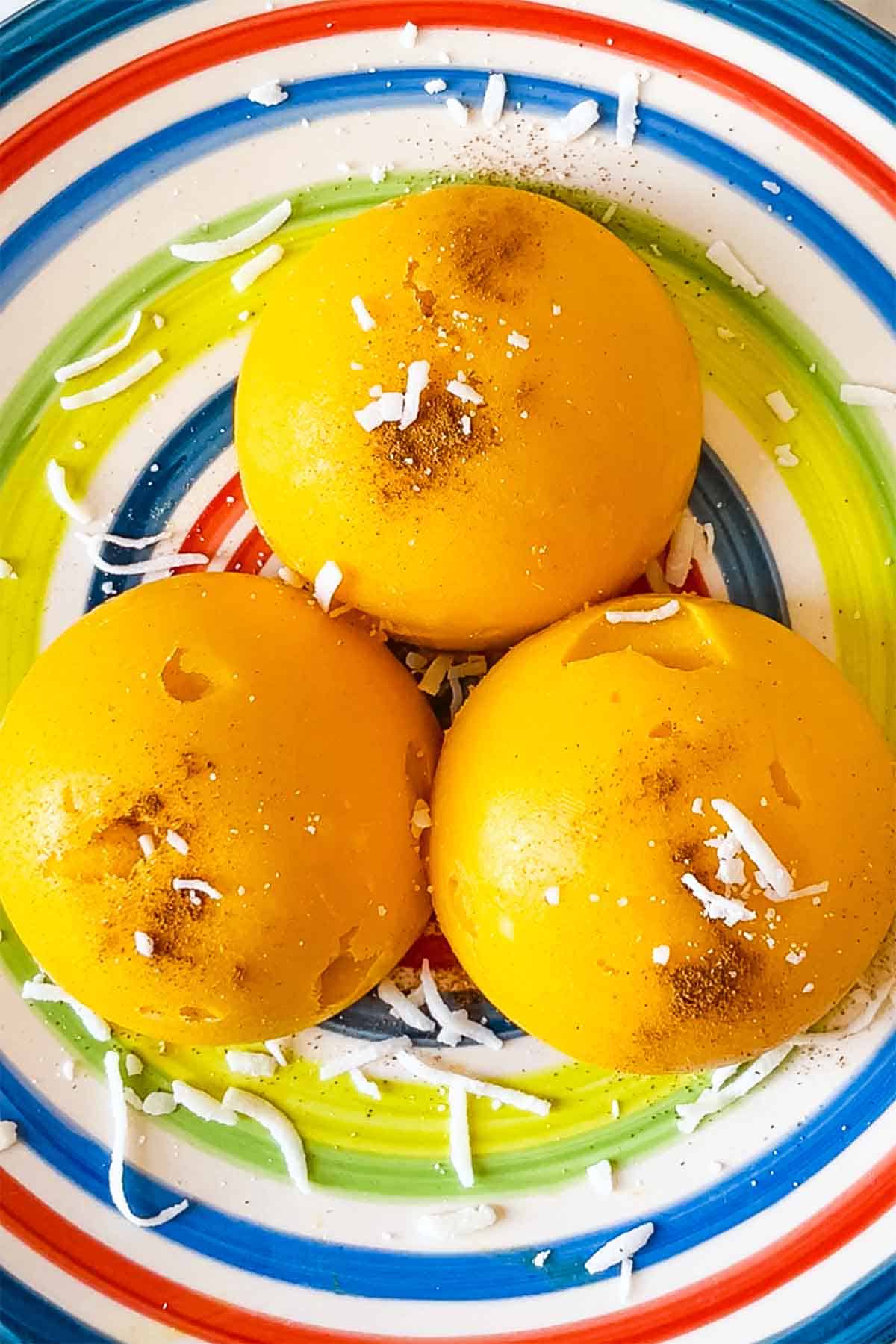 Mango sorbet spheres with cinnamon and coconut topping