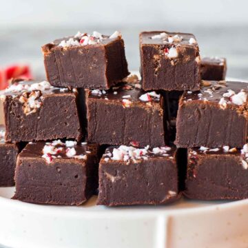 Mint chocolate fudge squares stacked on plate