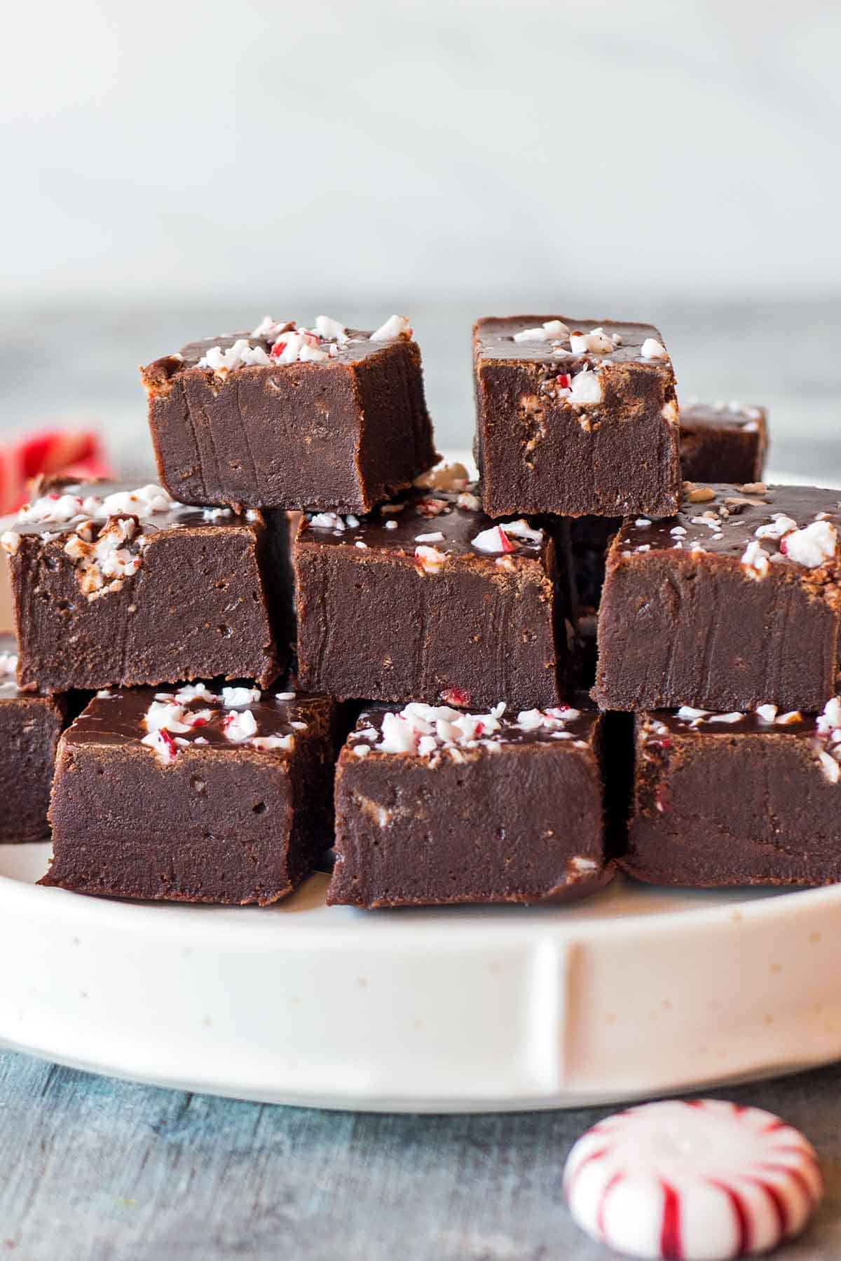 Mint chocolate fudge squares stacked on plate